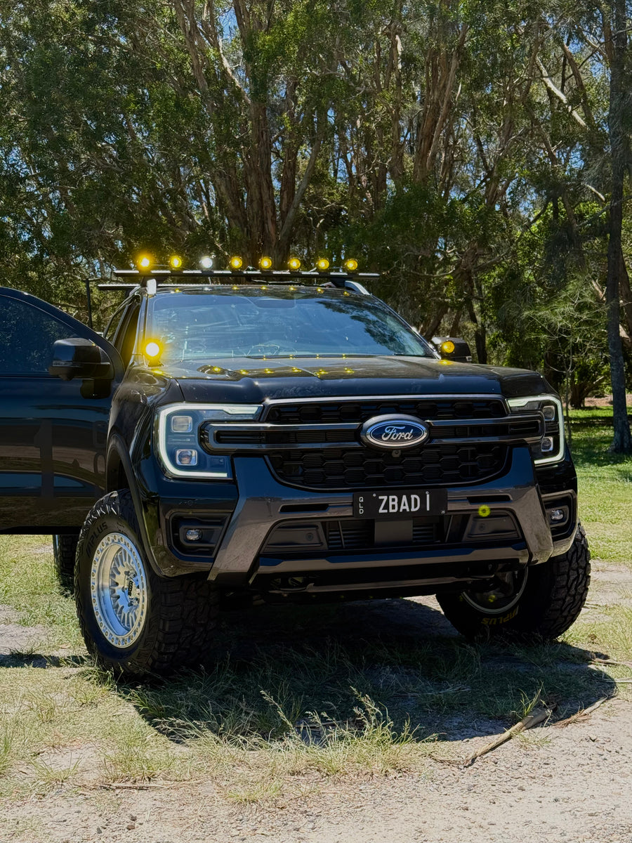 Black Ford Ranger fitted with ZBAD1 amber lights across the roof rack and bonnet