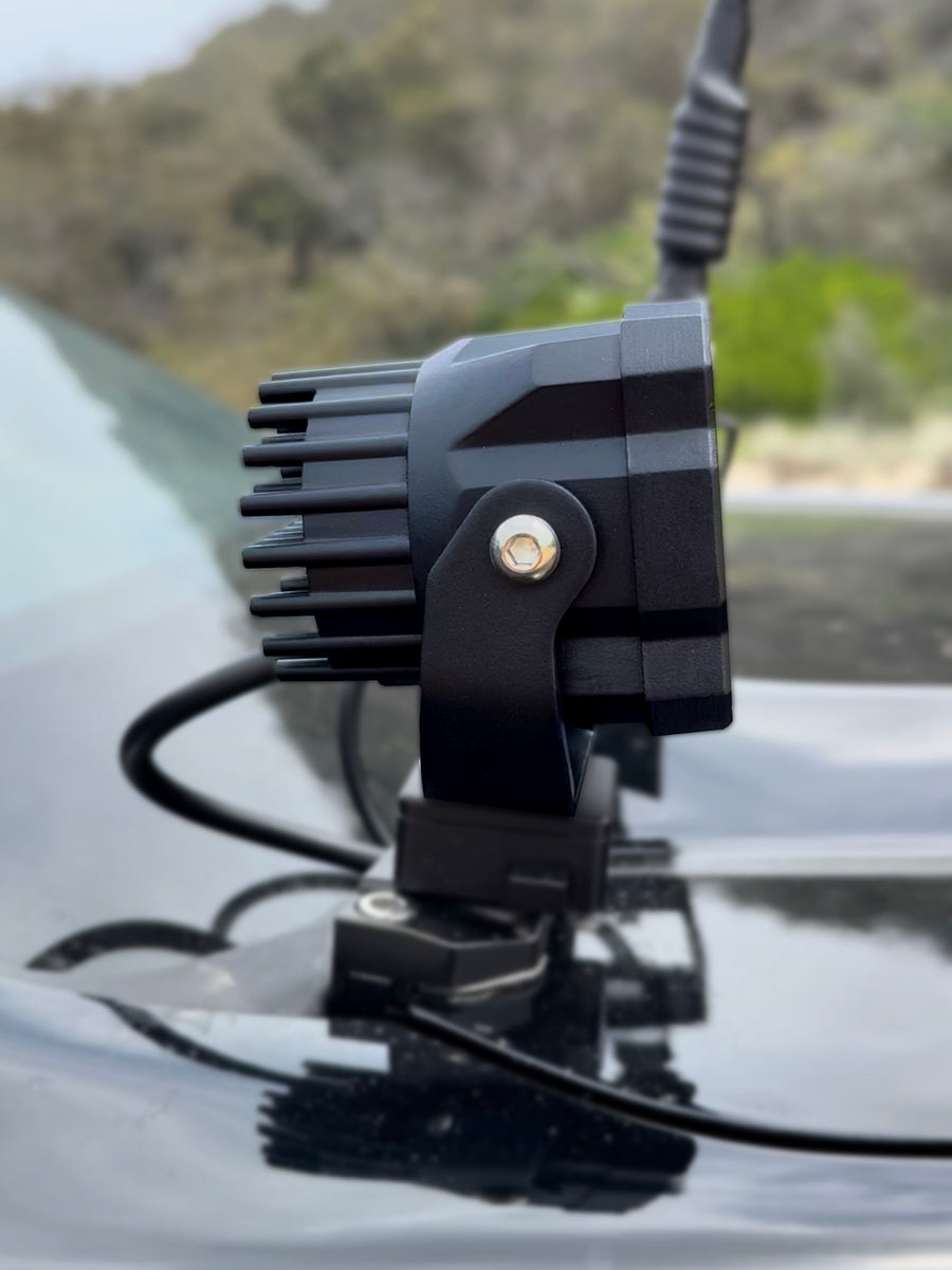 Side view of a ZBAD1 universal amber light showing cooling fins and mounting bracket on a bonnet