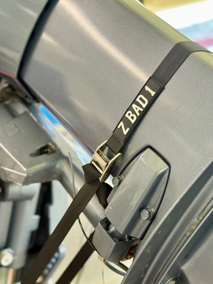 Black ZBAD1 marine tension strap secured around an outboard motor